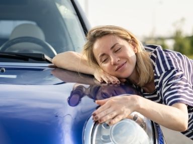 happy woman hugging her car