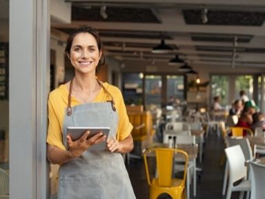 woman working in a restaurant and smiling